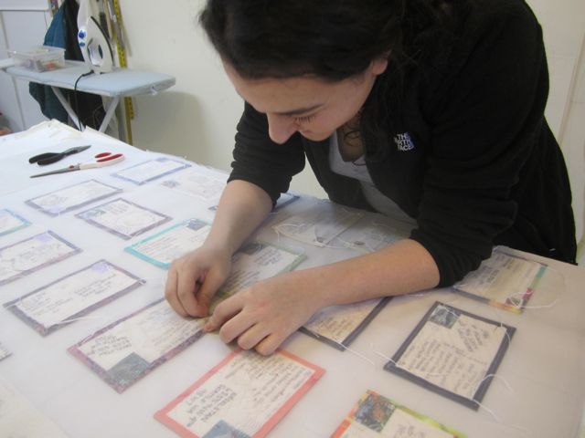 Talia sewing the postcards to the organza