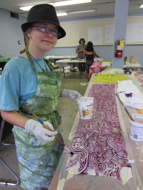 Thalia, one of our talented teens, painting dye on her scarf.